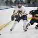 Chelsea's Joe Hewitt moves the puck past Shane Long as Chelsea High School took on Jackson Lumen Christi Wednesday December 14, 2011 at the Chelsea Arctic Coliseum. Chelsea won 6-5.  Jeff Sainlar I AnnArbor.com