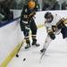 Chelsea's Taylor Atchley(right) and Blake Smith battle for possesion of the puck as Chelsea High School took on Jackson Lumen Christi Wednesday December 14, 2011 at the Chelsea Arctic Coliseum. Chelsea won 6-5.  Jeff Sainlar I AnnArbor.com
