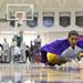 Ypsilanti's Janeau Joubert warms up with some diving on the floor exercises before Ann Arbor Huron took on Ypsilanti  at Huron High School Friday December 16, 2011. Ypsilanti won the game 66-57. Jeff Sainlar I AnnArbor.com
