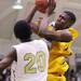 Ypsilanti's Lavonte Davis grabs a rebound over Demetrius Sims as Ann Arbor Huron took on Ypsilanti  at Huron High School Friday December 16, 2011. Ypsilanti won the game 66-57. Jeff Sainlar I AnnArbor.com