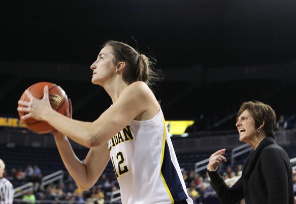 Michigan's Kate Thompson spots up for a three-point shot in front of Indiana State head coach Teri Moren as Michigan women's basketball team took on Indiana St Saturday December 17, 2011. Michigan won the game 72-44. Jeff Sainlar I AnnArbor.com
