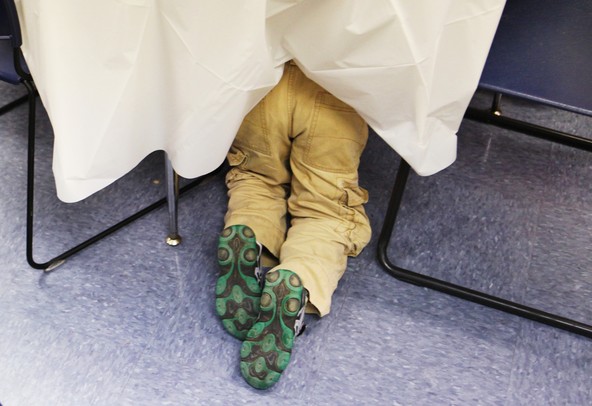 A kindergartner  looks under a table during a gingerbread man hunt at Lakewood Elementary School December 21, 2011. Certain schools throughout Washtenaw County are starting all-day kindergarten classes. Lakewood has an extended day option. Jeff Sainlar I AnnArbor.com