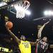Tim Hardaway Jr. hits a layup over Anthony Thompson as the Michigan men's basketball team took on Bradley at Crisler Arena Thursday December 22, 2011. Michigan won the game 77-66. Jeff Sainlar I AnnArbor.com